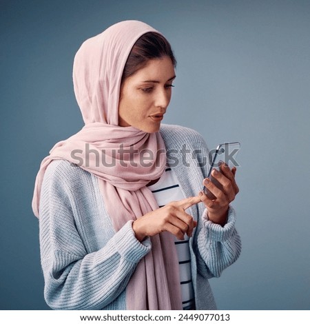 Muslim, girl and typing online with phone to search for Palestine, news and reading post on web. Contact, communication and woman scroll social media on smartphone in studio background or mockup