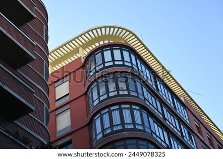 multi-story brick building with a rounded corner
