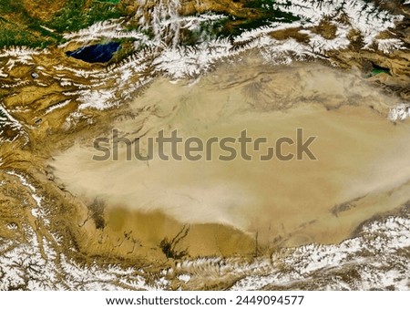 Dust Storm over the Taklimakan Desert. On May 10, 2007, a dust storm covered most of the Taklimakan Desert in western China. The Moderate. Elements of this image furnished by NASA.