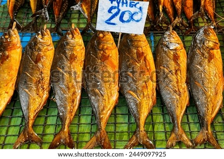 Freshly caught wild grilled fish with white price sign above