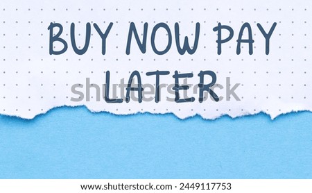 Torn paper with business motivational message on blue background, Buy Now Pay Later Royalty-Free Stock Photo #2449117753