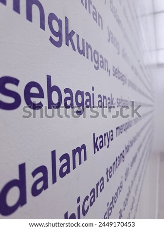 graffiti on the wall in Indonesian
 Royalty-Free Stock Photo #2449170453