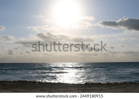 sunrise on the beach 
glare on the water