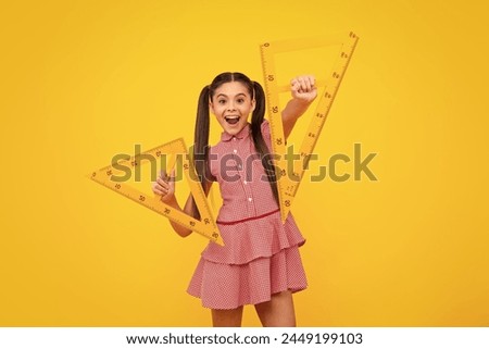 Teenager child school girl holding measure for geometry lesson. Measuring height. Measuring equipment. Kid student study math. Happy positive and smiling schoolgirl.