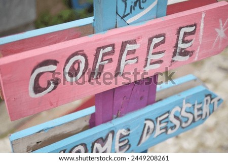 A sign at a coffee shop offering different types of coffee.