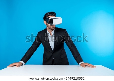 Business man planning financial plan while using VR goggle. Professional project manager looking and thinking marketing strategy while using visual reality glasses to connect metaverse. Deviation.