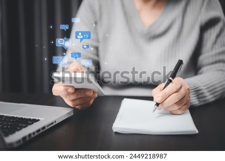 She used love icon to share her message on social media, showcasing her affection through heartfelt post in marketing strategy aimed to engage broader audience. comment phone, social media concept. Royalty-Free Stock Photo #2449218987
