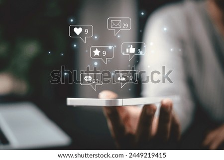 She used love icon to share her message on social media, showcasing her affection through heartfelt post in marketing strategy aimed to engage broader audience. comment phone, social media concept. Royalty-Free Stock Photo #2449219415