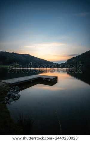 Lake in sunset. Beautiful landscape. Located in the middle of the forest and surrounded by nature, the reservoir offers a great atmosphere. Marbachstausee, Odenwald, Hesse, Germany Royalty-Free Stock Photo #2449230023