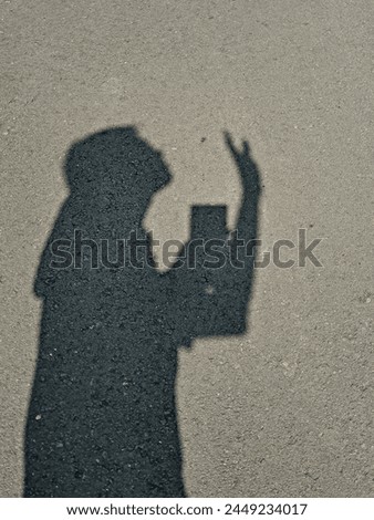 Man's shadow on the road