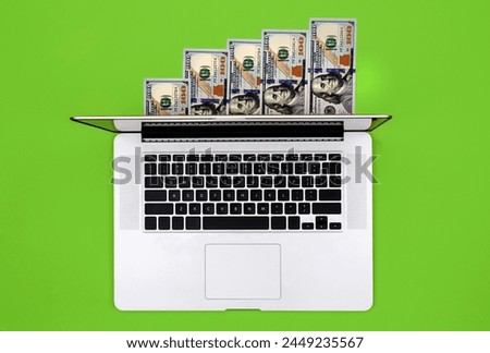 Laptop and dollar bills on colored background, flat lay, concept of freelancing, remote work, work online and work from home. Royalty-Free Stock Photo #2449235567