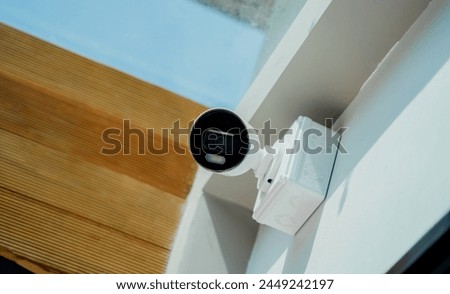 Modern CCTV camera on a wall of a residential building Royalty-Free Stock Photo #2449242197