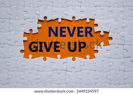 Never give up symbol. Concept words Never give up on white puzzle. Beautiful orange background. Business and Never give up concept. Copy space.