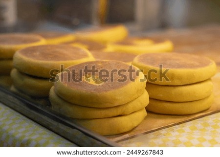 Horizontal photograph of a small Mexican snack retail business selling gorditas de nata in the local market for tourists on vacation in Mexico