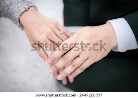 Newly wed couple's hands with wedding rings. Picture of man and woman with wedding ring.Young married couple holding hands, ceremony wedding day.