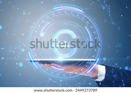 Close up of male hand holding smartphone with creative round euro sign on blurry blue polygonal background. Crypto, online banking, digital transformation and finance concept
