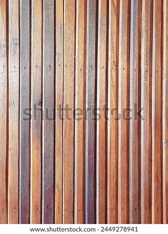 a photography of a wooden wall with a fire hydrant in the middle.