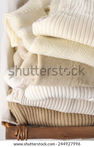 Stack of warm sweaters close-up.