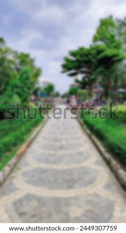 A blurry photo of a cool park with a beautiful and precise straight path with trees on the sides which looks very cool Royalty-Free Stock Photo #2449307759