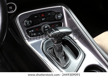 Supercharged muscle car Automatic gearbox lever. Automatic gear stick inside modern car. Detail on a automatic gear shifter in a car. Royalty-Free Stock Photo #2449309091