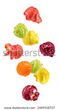Falling Colored fruity popcorn isolated on white background, clipping path, full depth of field