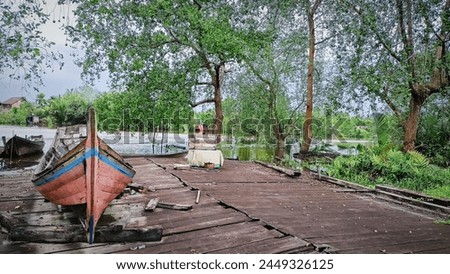 This is a picture in the village, showing a canoe and a river.