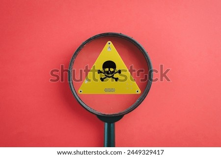 Danger,Caution,Warning,Alert,notification,sign,No entry,Hazard Sign,Attention sign,Exclamation mark concept.,Magnify glass focus on yellow danger sign.