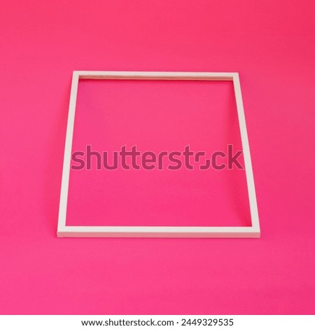 Blank white photo frame on pink background creative background concept. Copy space for text. 