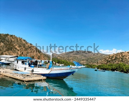 the texture of the pinisi ship at anchor and mountains. pinisi mountains background. background