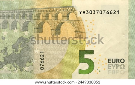 Fragment of one five euro money bill. Colorful details of European union currency banknote of five euro close up.