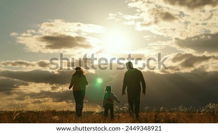 Happy family, daughter, mom, dad play run in park in sun. Running child along with mother and father on grass, family game. Parents, kid, walks in natural park, relaxation, joy in nature. Happy people