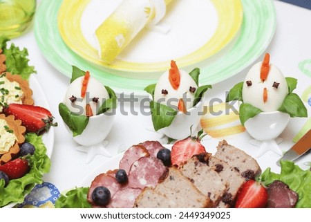 Funny easter decoration. Eggs as chickens. Family morning holiday breakfast table. Festive home food background.