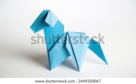 Animal concept origami isolated on white background of a blue horse - Equus caballus - with copy space side view of mane and tail, simple starter craft for kids