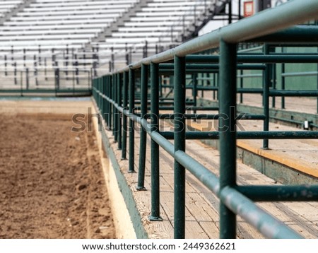 Grandstand Fence with a diminishing perspective in a Horse Arena. Royalty-Free Stock Photo #2449362621