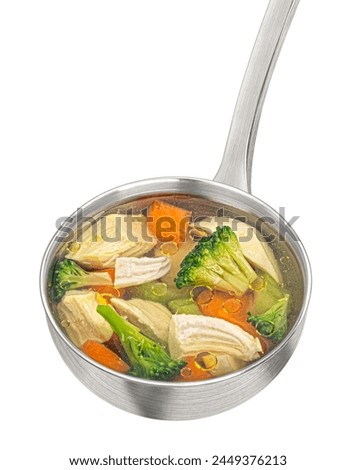 Ladle with chicken soup with vegetables isolated on white background, top view