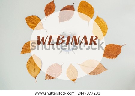 A circle of leaves with a clock in the center and the word webinar written around it