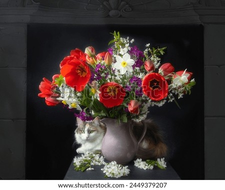 Bouquet of spring flowers in vase and curious kitty
