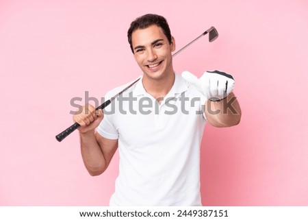 Young golfer player man isolated on pink background with thumbs up because something good has happened