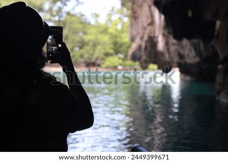 Tourist taking picture from inside Underground River in Puerto Princesca, Palawan, Philippines on April 4, 2024