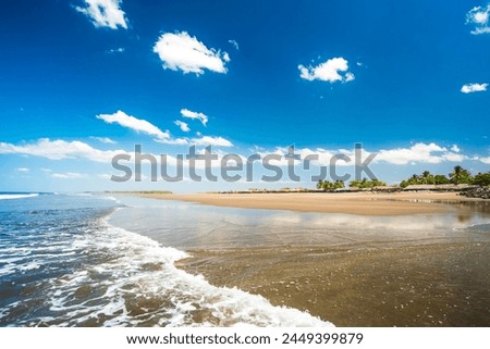 "Paso Caballos" Beach. Chinandega, Nicaragua. Beautiful summer day at relaxing tropical beach. Blue sky, soft waves kissing the shoreline.