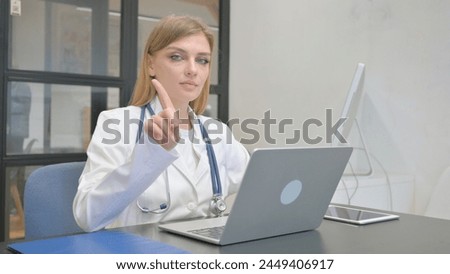 Female Doctor Shaking Head in Denial at Work