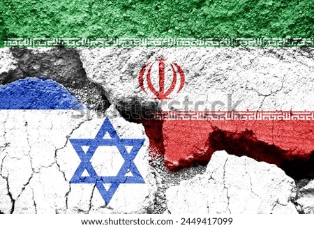 Flags of Israel and Iran on cracked background, Israeli Iranian conflict or war symbol Royalty-Free Stock Photo #2449417099