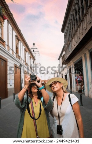 Two excited European tourists take a photo to remember their trip to Lima Peru.