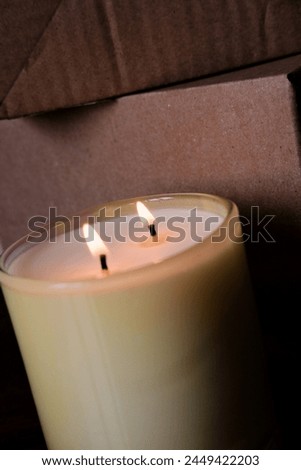 large glass jar with natural candles. burning soy wax candle close up.