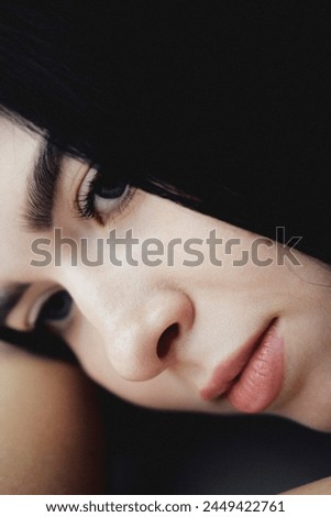 young brunette woman with blue eyes. close-up portrait of a brunette woman. woman looking away