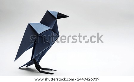 Animal concept paper origami isolated on white background of a black crows, magpie or raven with copy space, simple starter craft for kids