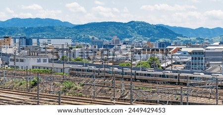 Detail of local railway station with contact lines, traffic signals and rails in Kyoto, Japan. Japanese industrial background. 