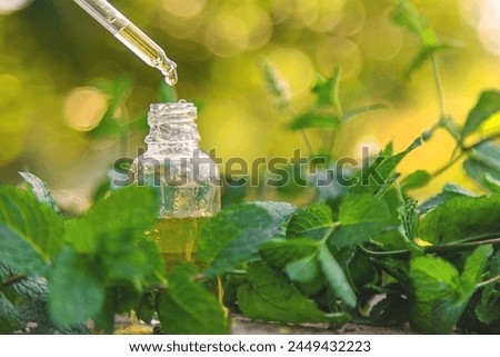 Peppermint essential oil in a bottle. selective focus. nature.