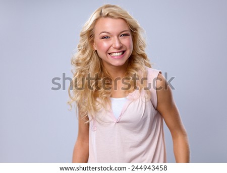 Young emotional woman, standing on gary background