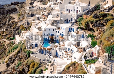 Houses, bungalows in Thera and Oia, two small villages on the crater rim of the Greek island of Santurini in the Aegean Sea in the midday sunlight with a view of the volcanic crater